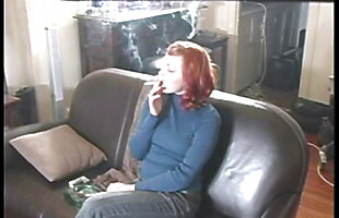 Sexy Redhead On Leather Couch Smoking A Cigarette